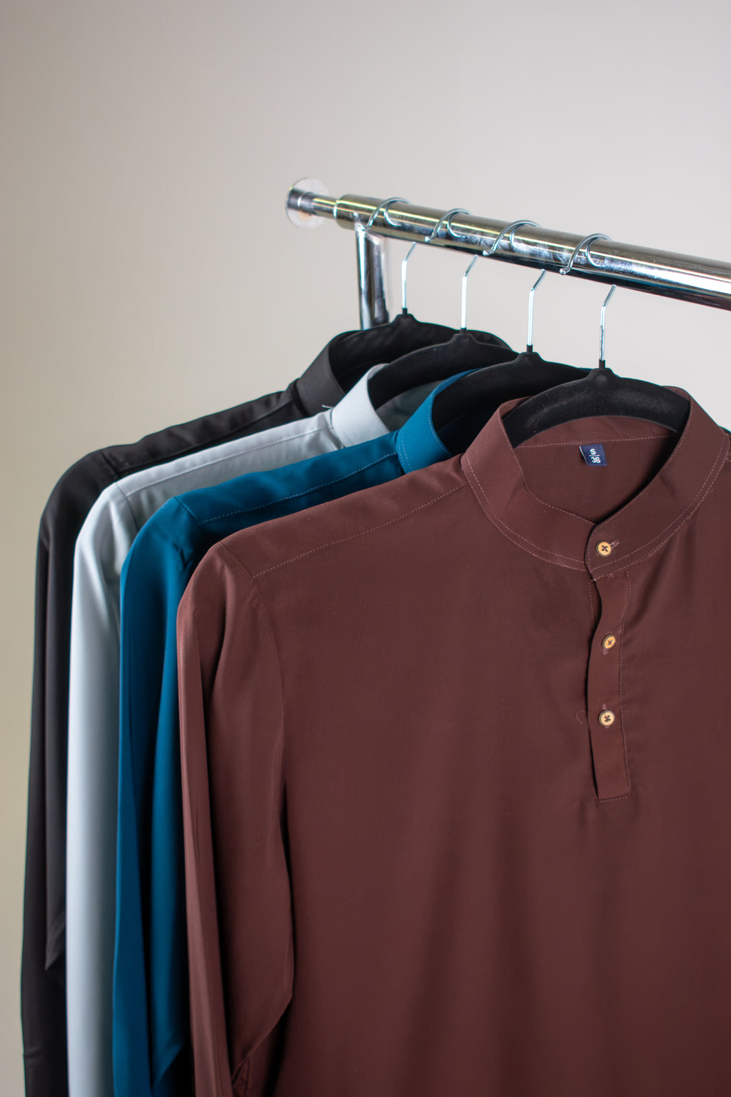 Rawi Short Kurta in Smooth Finish, all four colors on hangers: Brown, Teal, Grey and Black